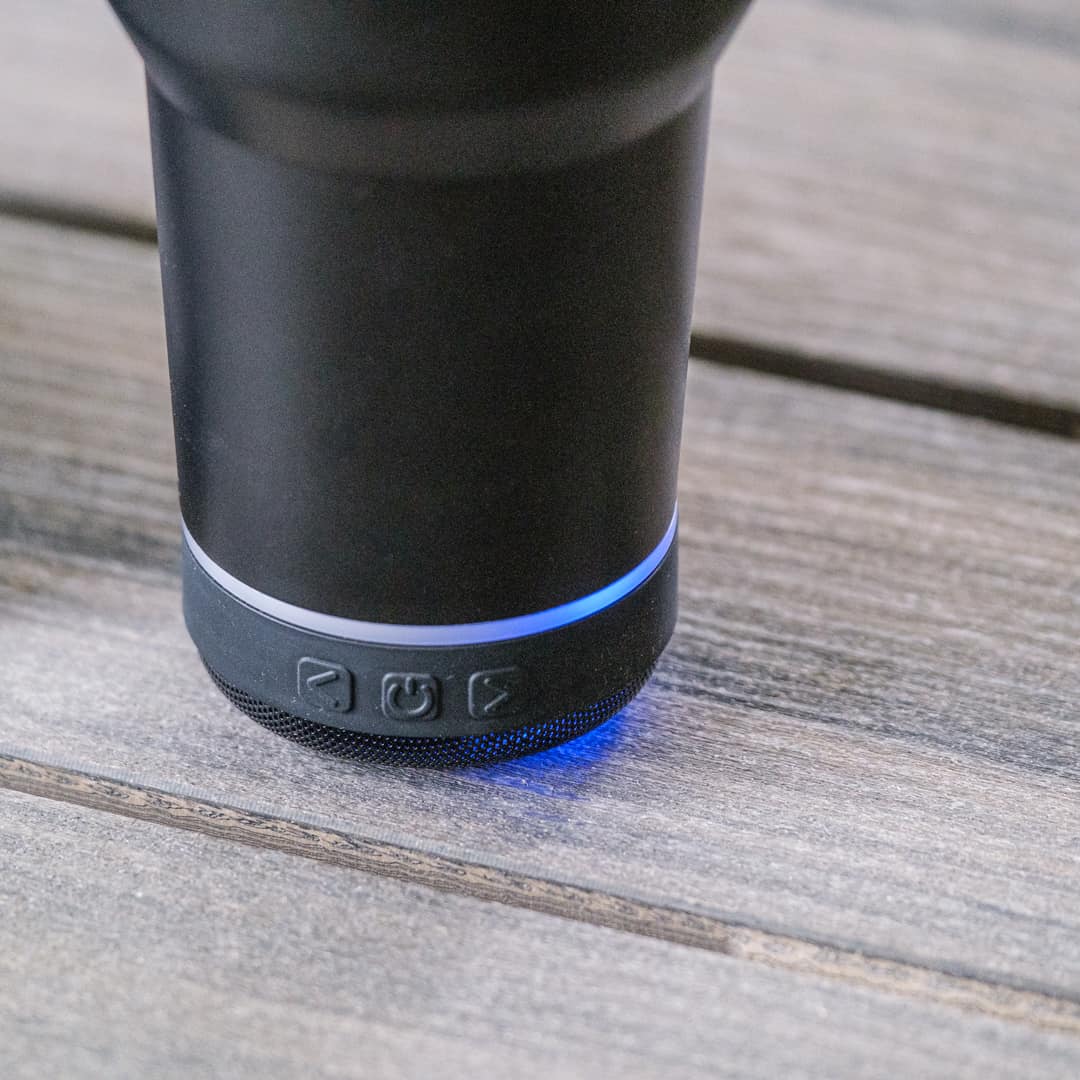 Black electronic device with blue light on a wooden surface