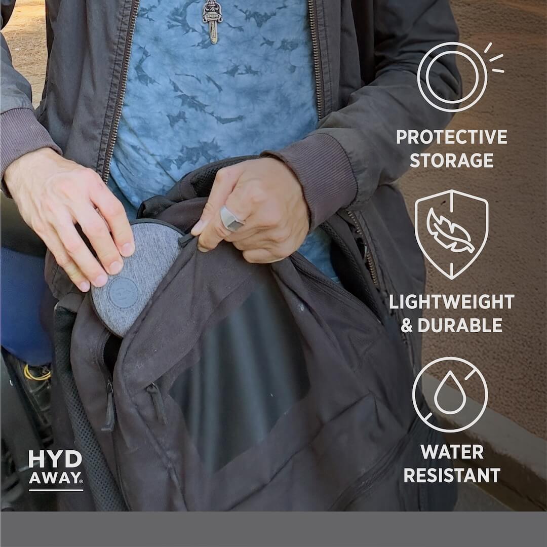 Person holding a jacket with protective storage features highlighted on the right side.