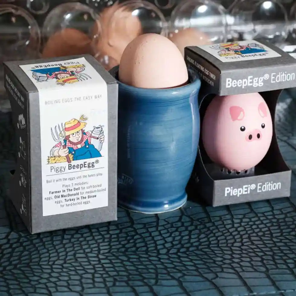 Egg-shaped product with packaging labeled 'Piggy BeepEgg'  on a textured surface.