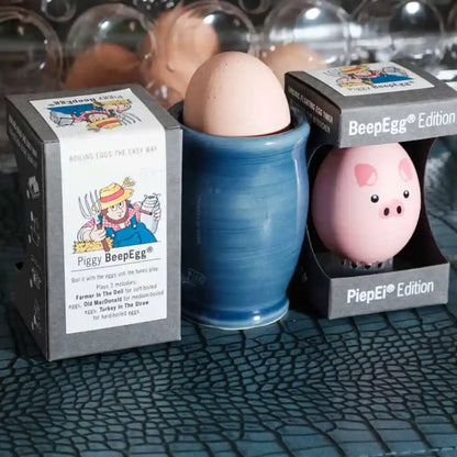 Egg-shaped product with packaging labeled 'Piggy BeepEgg'  on a textured surface.