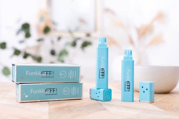FunkkOFF! toothbrushes and their matching boxes arranged on a light wooden surface with a softly blurred indoor background.