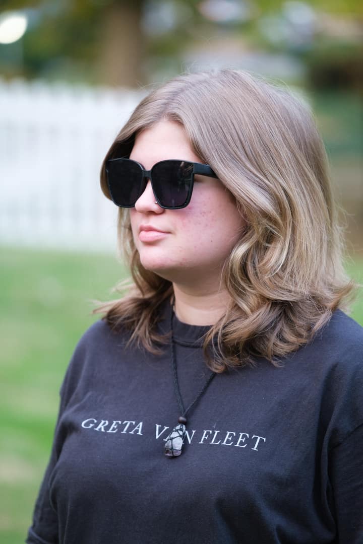 Person wearing sunglasses and a black 'Greta Van Fleet' shirt outdoors