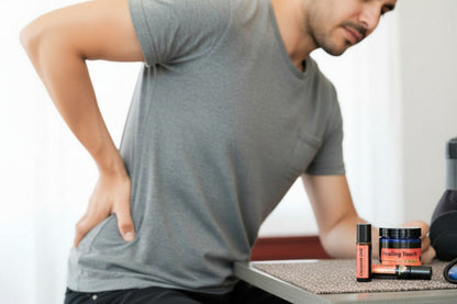Man holding his back and reaching for a bottle of healing touch