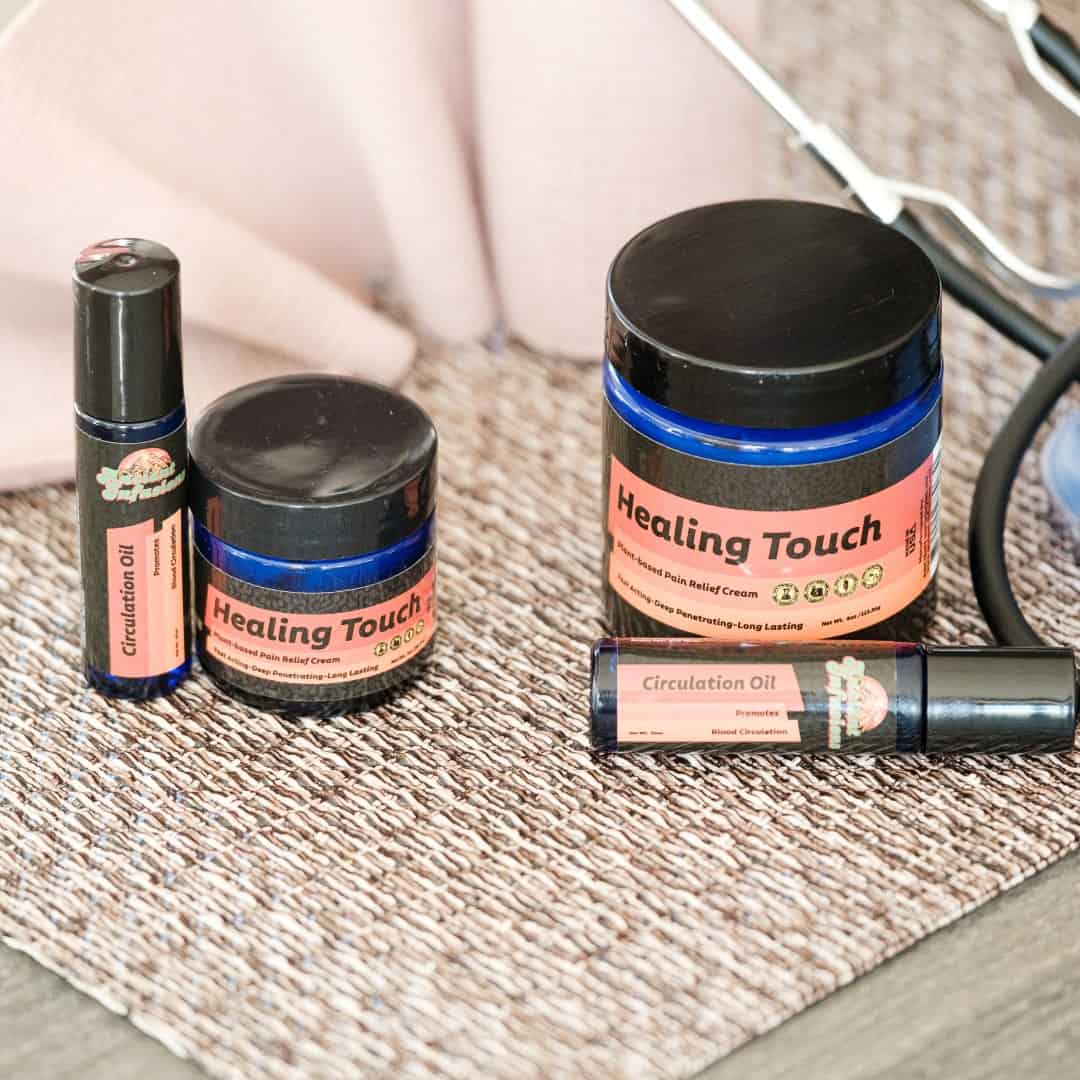 Healing Touch products including jars and a bottle on a textured surface with a stethoscope in the background.