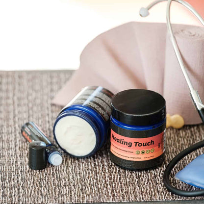 Cosmetic jar labeled 'Healing Touch' with a stethoscope on a textured surface.