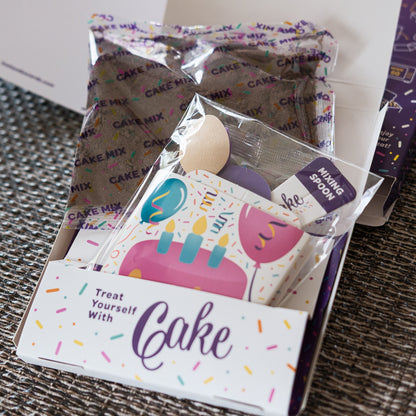 Insta Cake card with cake mix with a spoon and card on a textured surface