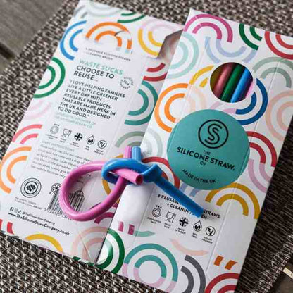 Silicone straw packaging with colorful design and branding on a textured surface