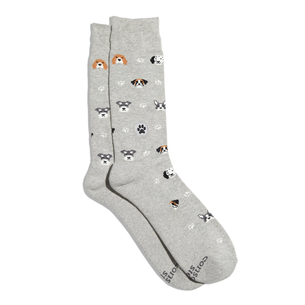 A pair of light gray crew socks with a pattern of different dog breeds and small paw prints, displayed on a clean white background.